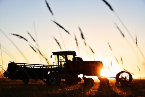 Tractor in field at sunset provides financial assistance for farmers, ranchers and forest landowners who experienced discrimination in USDA farm lending programs prior to January 2021. 