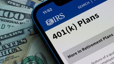 Phone displaying IRS website and cash money