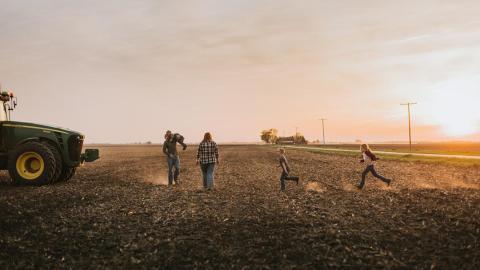 Farm family walking in field
