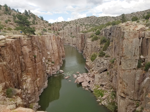 A canyon split by river water
