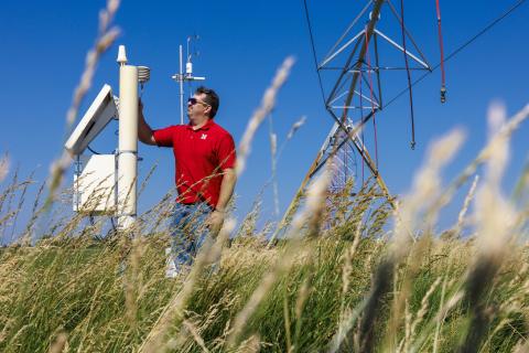 Man stands near equipment in field