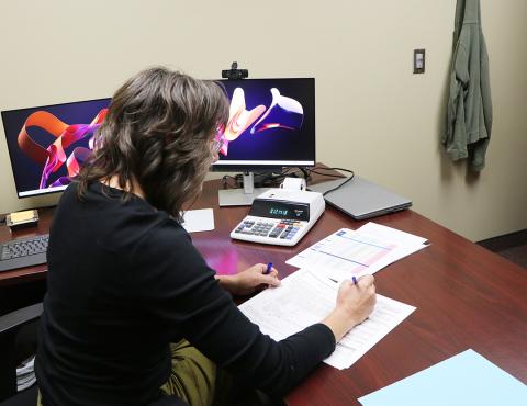 Woman works on taxes at desk