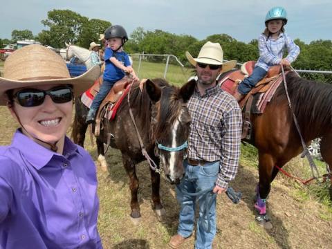 Family poses with horses