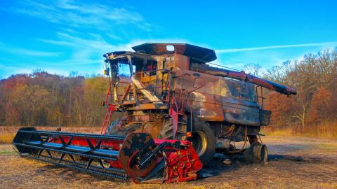 Burned combine in field