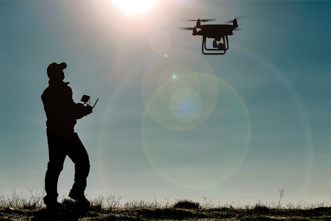 Man operating drone in field