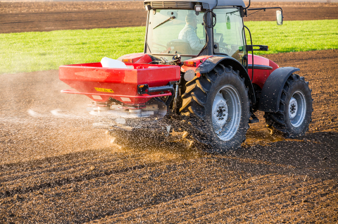 Tractor applies fertilizer to field