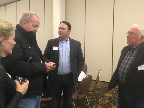 Discussing irrigation management at the annual UNL-TAPS banquet were (L-R): UNL-TAPS competitors Carla McCullough, Roric  Paulman, and Tim Franklin, and Gerald Franklin. (Photo by Amy Kremen)