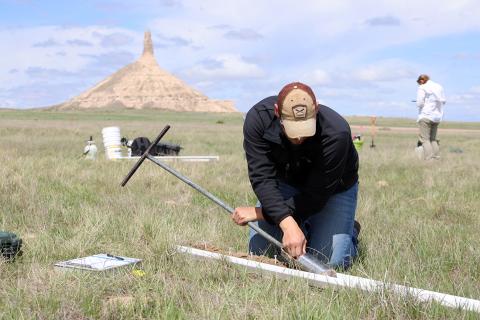 Riley Hackbart using soil probe